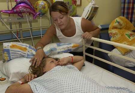 BEDSIDE VIGIL: Rose Brighty with her daughter Chelsea, six, at William Harvey Hospital. Picture: CHRIS DAVEY