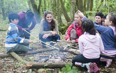 The Duchess of Cambridge talks to children around a campfire
