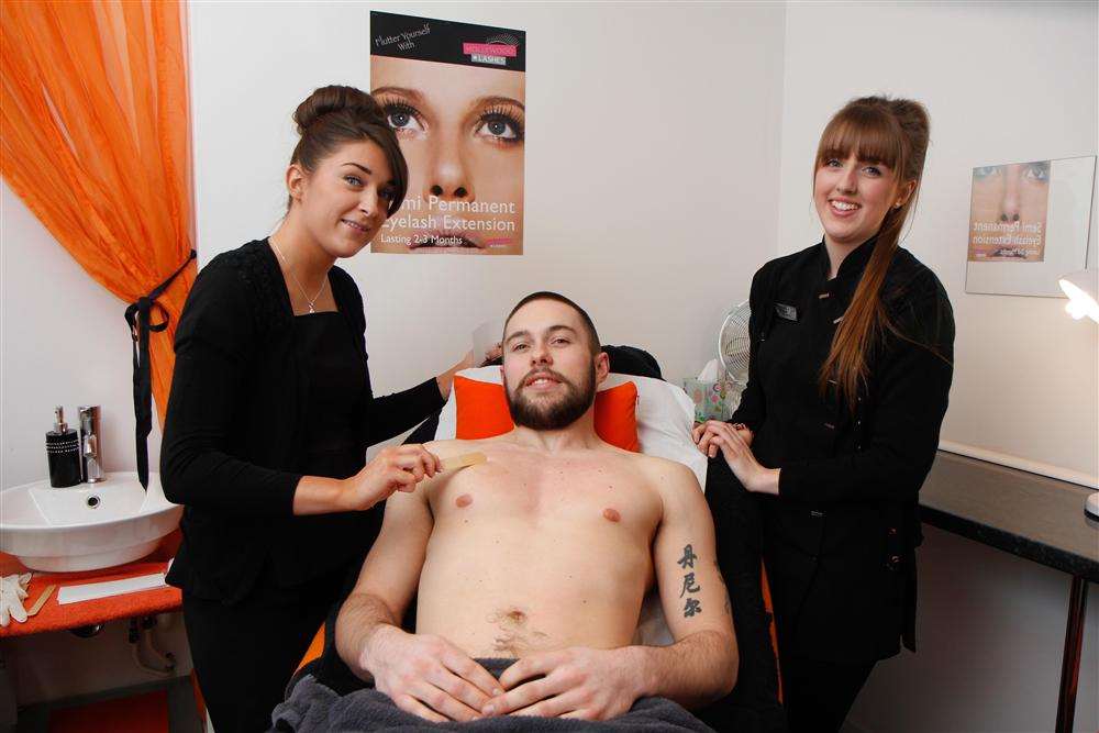 Ginger Body and Soul therapists Alice Jackson and Kyah Dooley wax Dan Motterham for charity