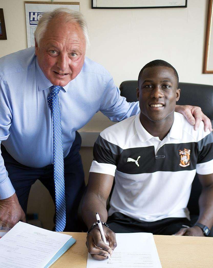 Folkestone Invicta striker Ade Yusuff signs his new contract with manager Neil Cugley Picture: Don Linkin