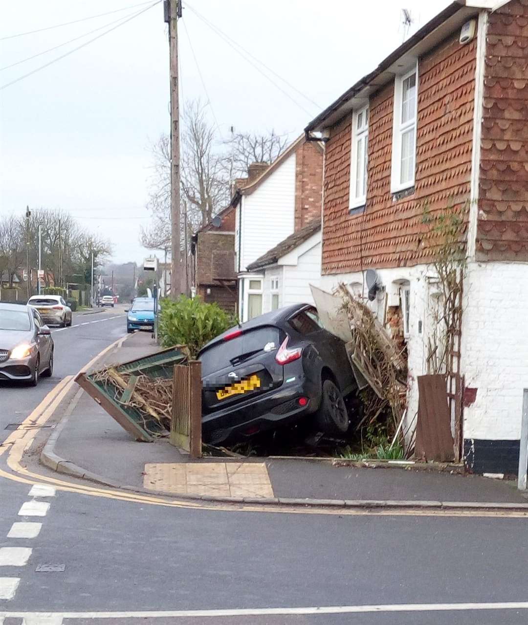 A black Nissan crashed into a house in Wheeler Street, Headcorn, at around 6.15am. Picture: Keith Armstrong