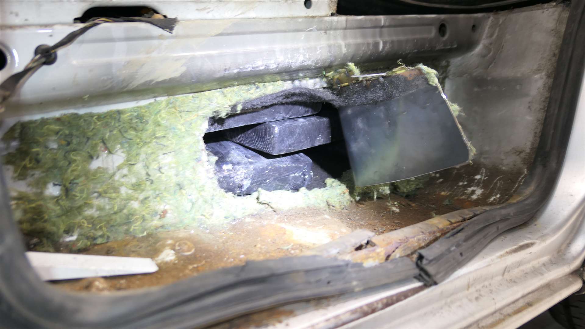 The 15 kilos of cocaine were hidden behind the doorstep underneath the driver and passenger seats Picture: NCA