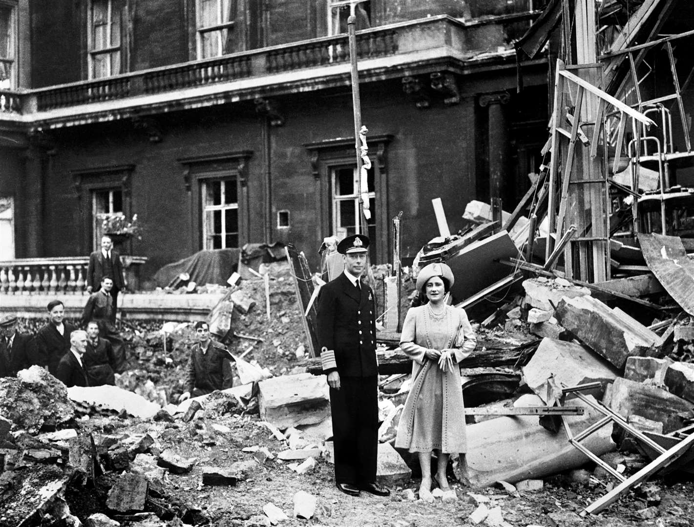 The King and Queen stand amid the bomb damage at Buckingham Palace (PA)