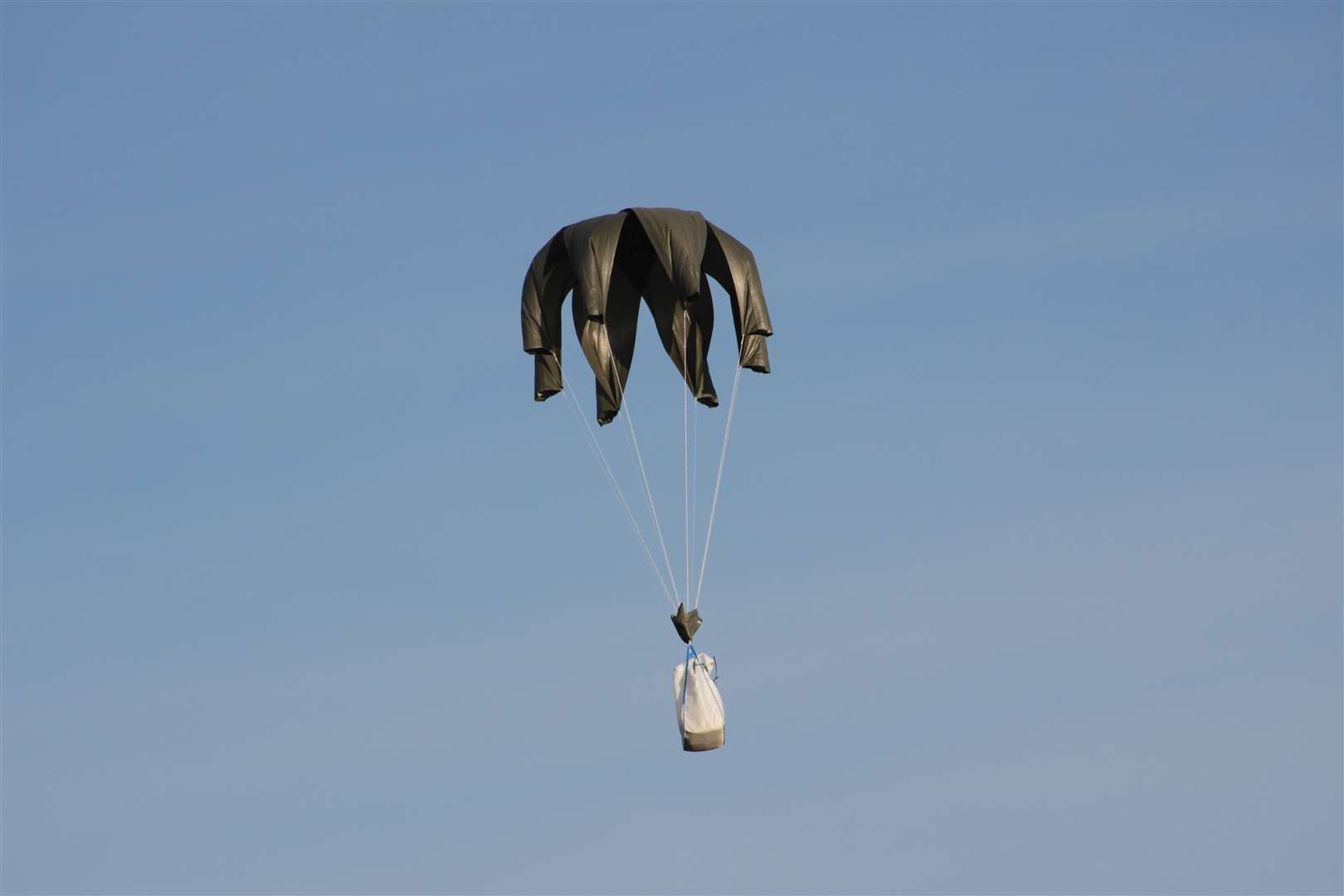 Air Drop Box packages are dropped from a plane by parachute during testing at Headcorn Aerodrome