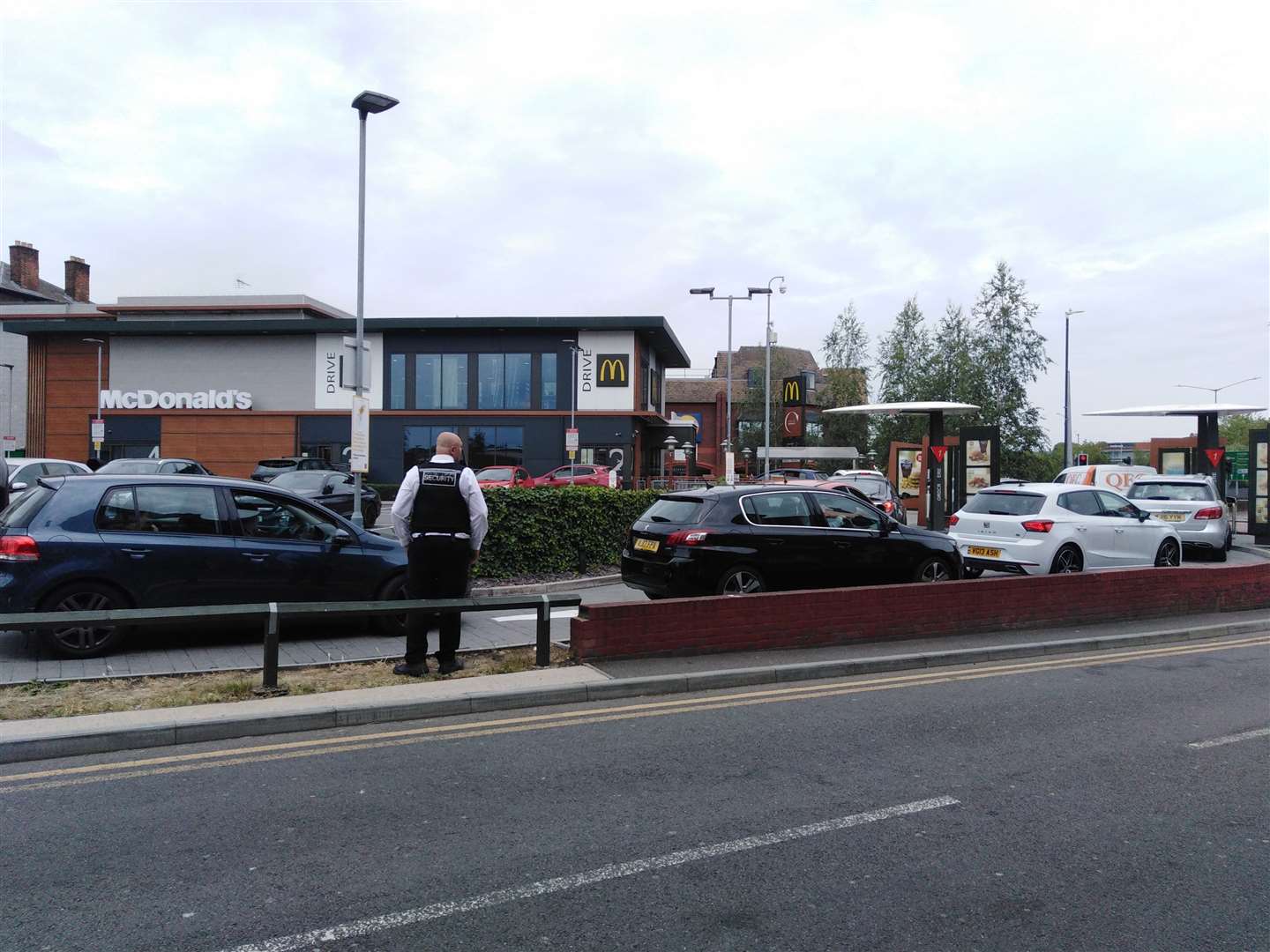 A security guard who normally works at the Week Street McDonald's is now manning traffic at Hart Street drive-thru