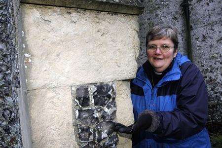 Rev Elizabeth Cox shows the crumbling plaster work on the tower of St Mary Magdalene Church that needs attention.