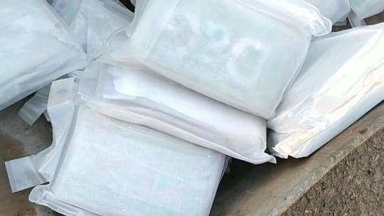 Blocks of cocaine pictured in a wheelbarrow were also shared on Tahir's phone