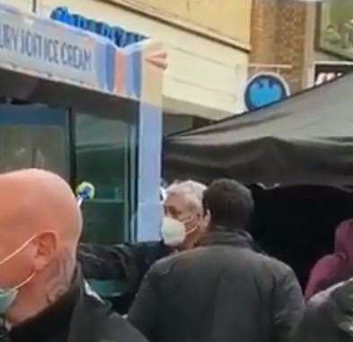 Schwimmer, protected by security guards, is filming by an ice cream van in Canterbury High Street