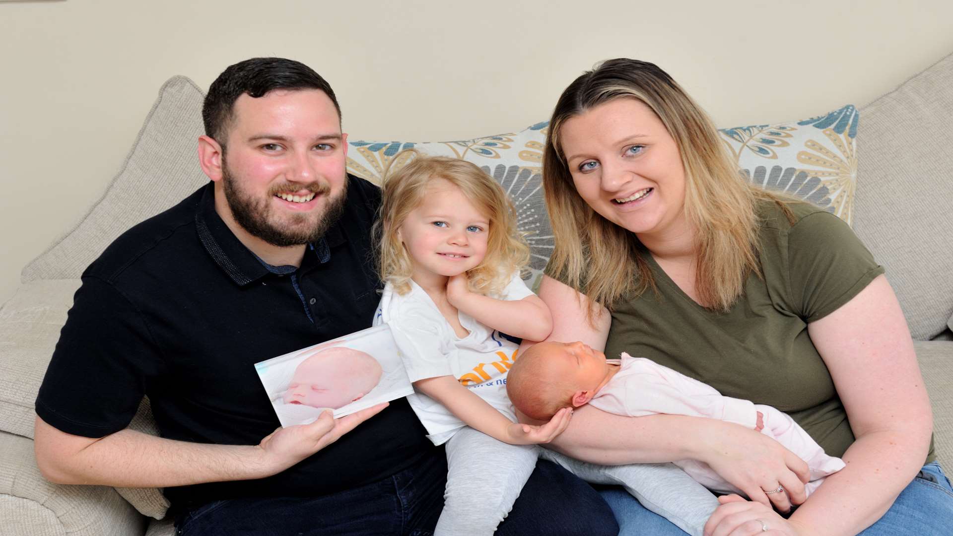 L/R: James, with pic of baby Ronnie, daughters Elsie-Rae, two, and Pennie, Demi