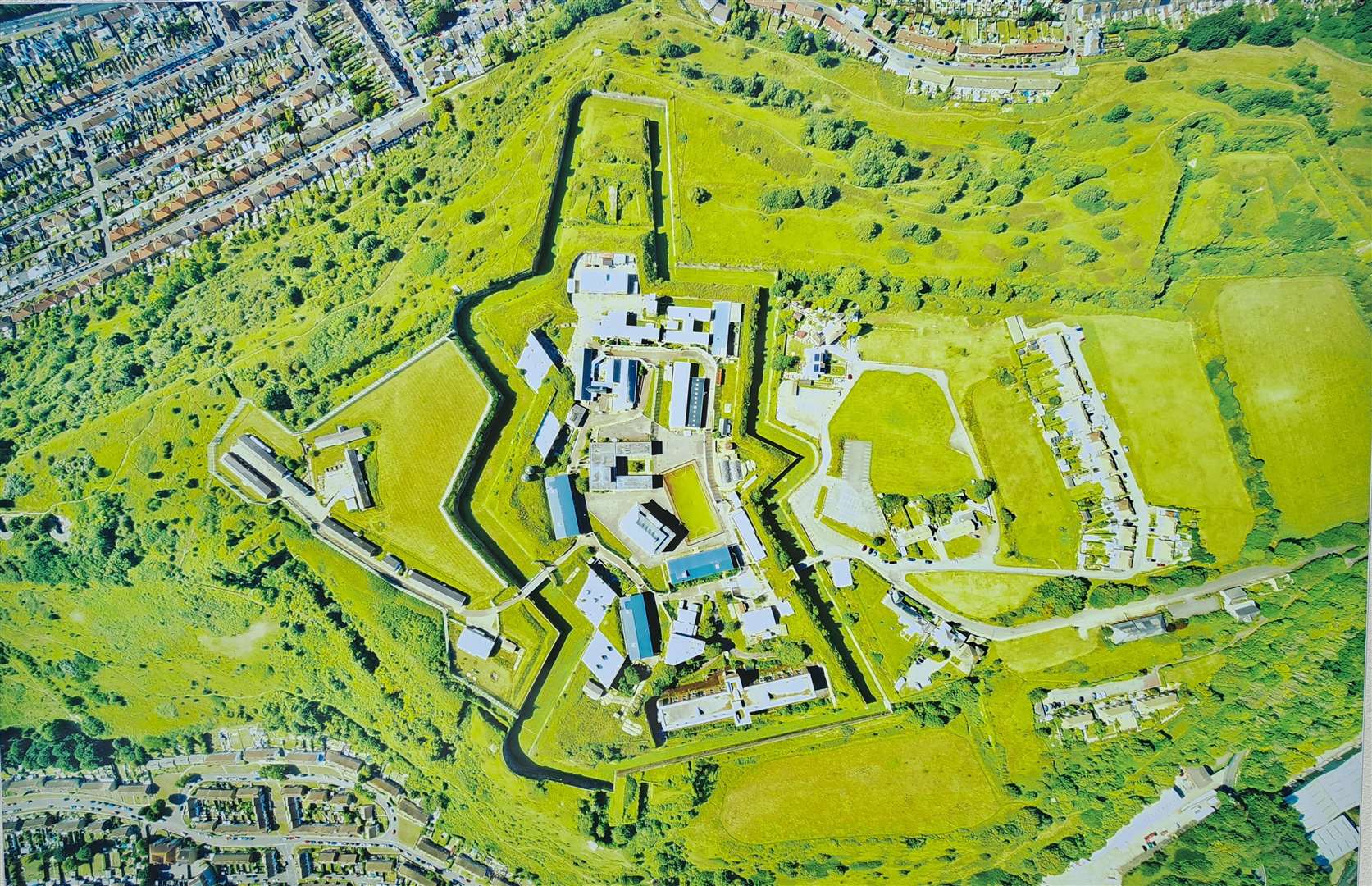 Aerial photograph of the Citadel complex. The distinctive Officers' Quarters are at the bottom. The streets on the top left are in Maxton top right; bottom left, Aycliffe. Original image from Dover Citadel Ltd