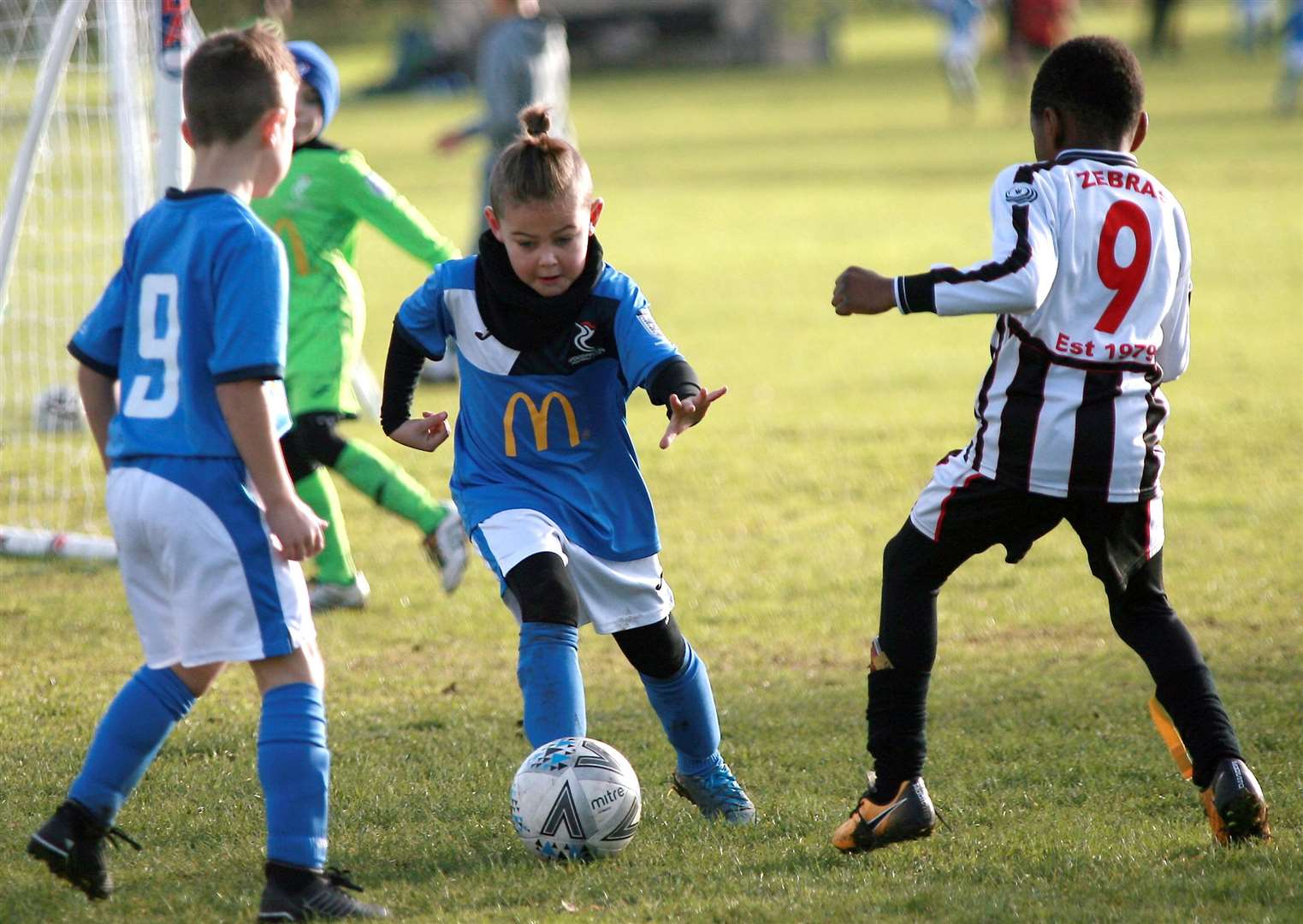 Woodpecker Rovers under-7s (blue) on the ball against Milton & Fulston under-7s Picture: Phil Lee FM23734086