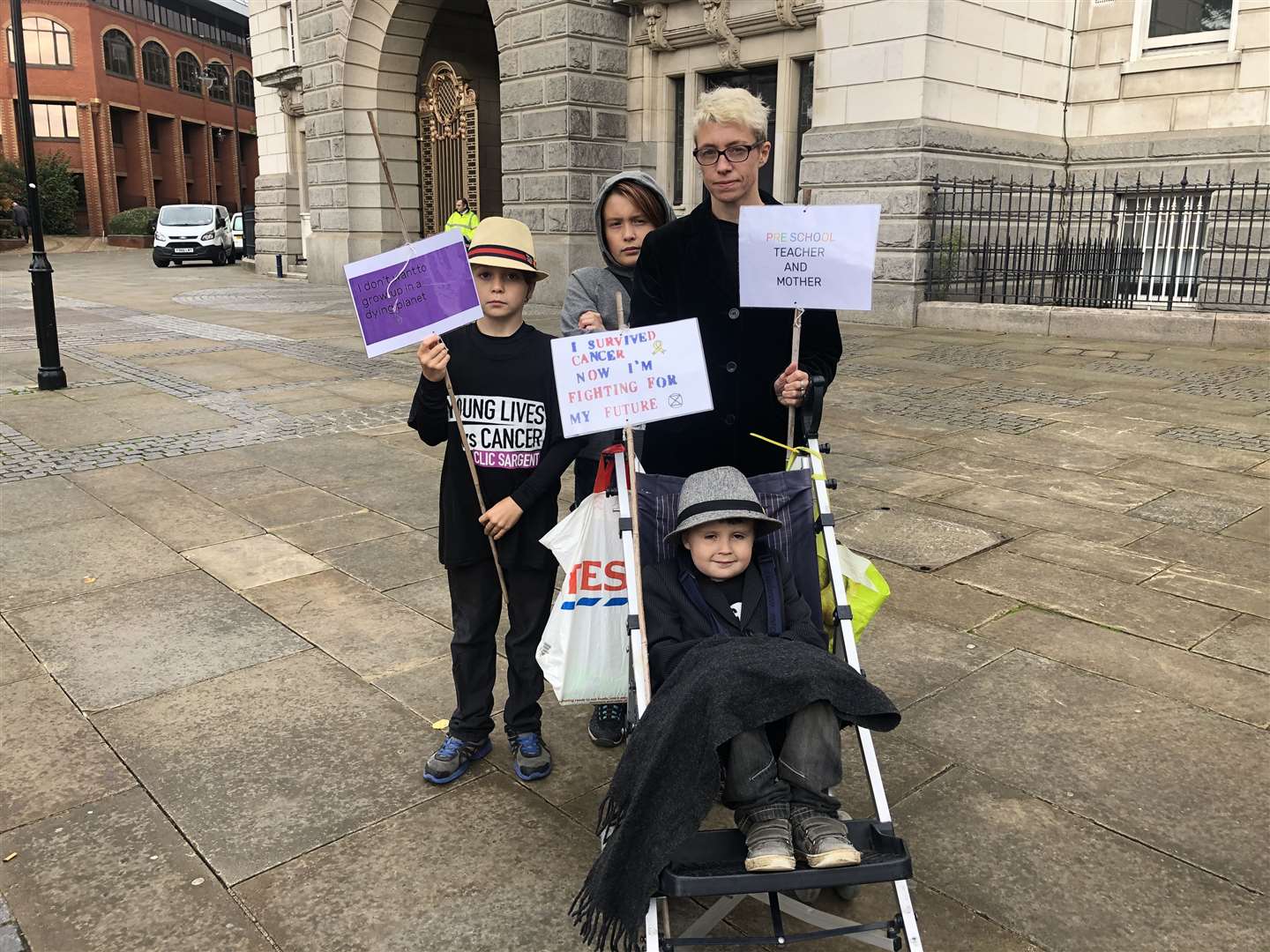Extinction Rebellion protestors take to the streets in a funeral march. Sam Dickenson, 42, from Maidstone. Pictured with sons. From left to right: Rufus, 9, Arthur, 12 and Seth, 5. (19542208)