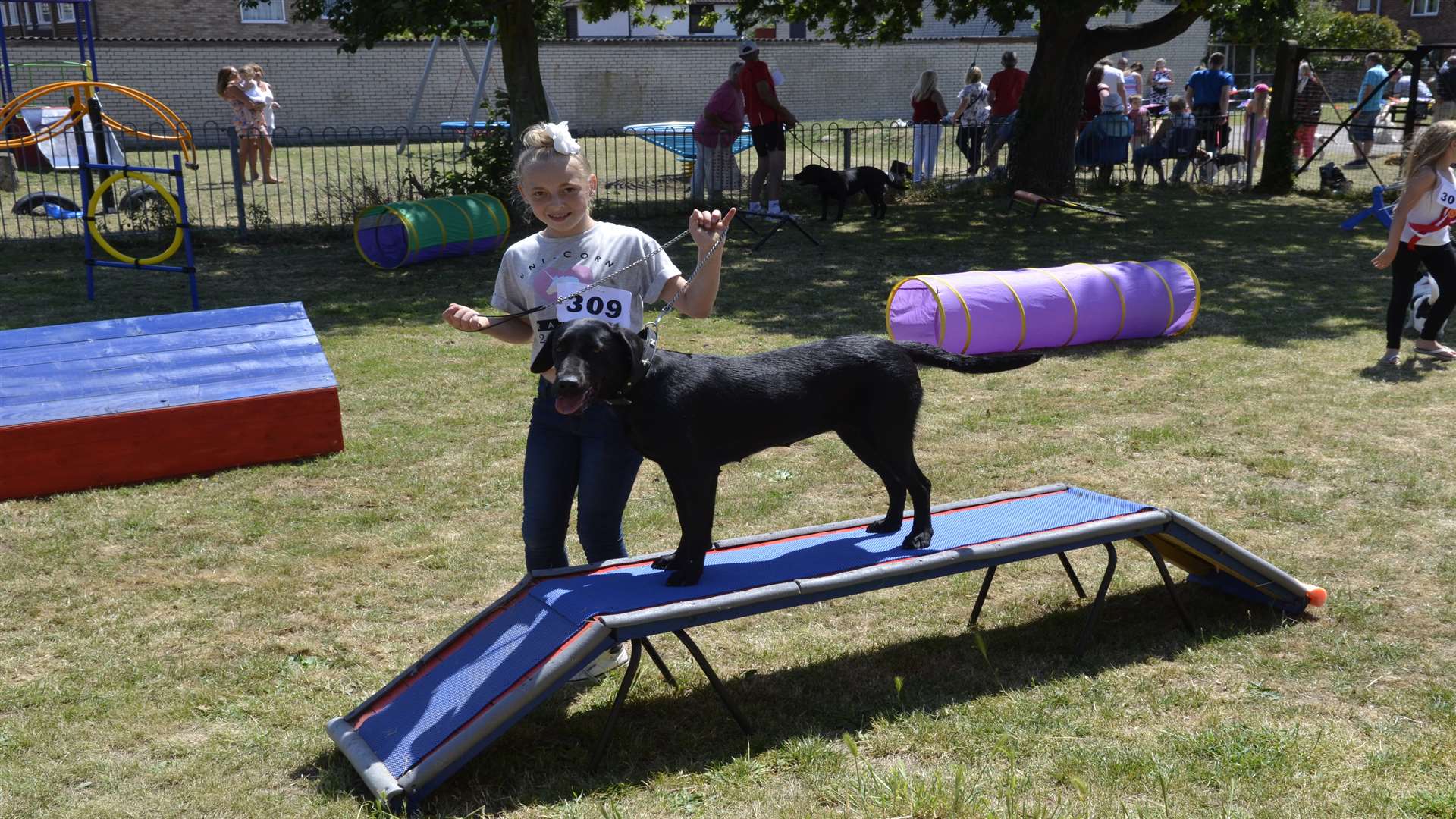 Cherry Richardson, 11, with her dog, Ellie, on one of the agility course props