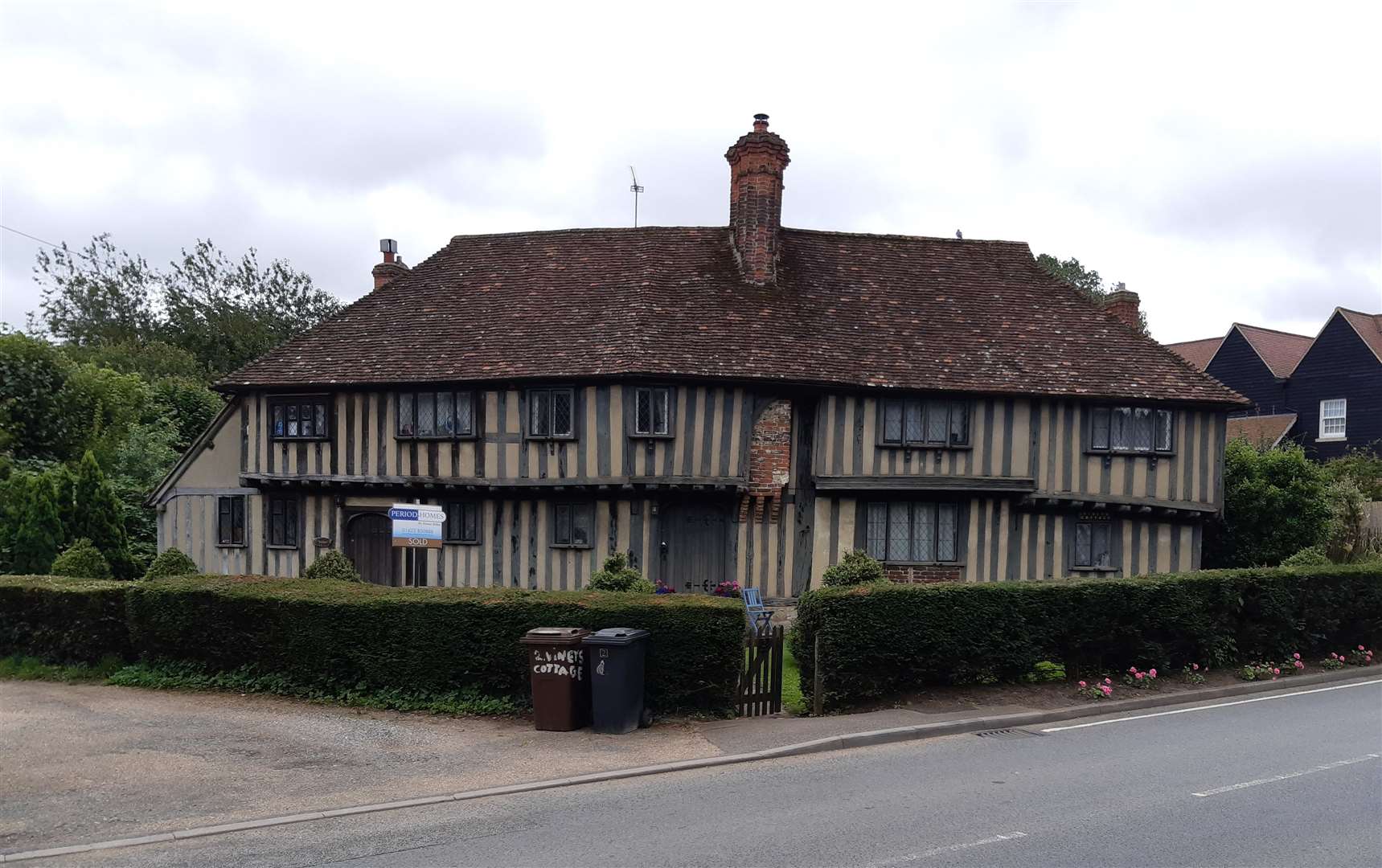 This lovely house stands on the B2163, the busy road through the village