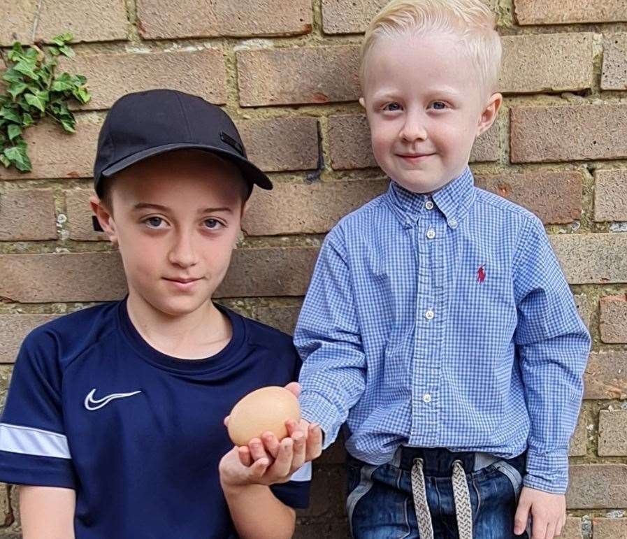 Kieran, 11, and Henry, 4, with one of the giant eggs. Picture: Samantha Oliver