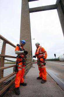 Workmen preparing to abseil down the side of the Kingsferry Bridge