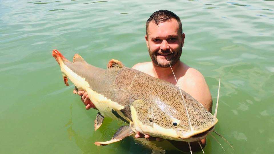 Kevin Rowlands holds up a catch at Gillham's Fishing Resort on Krabi