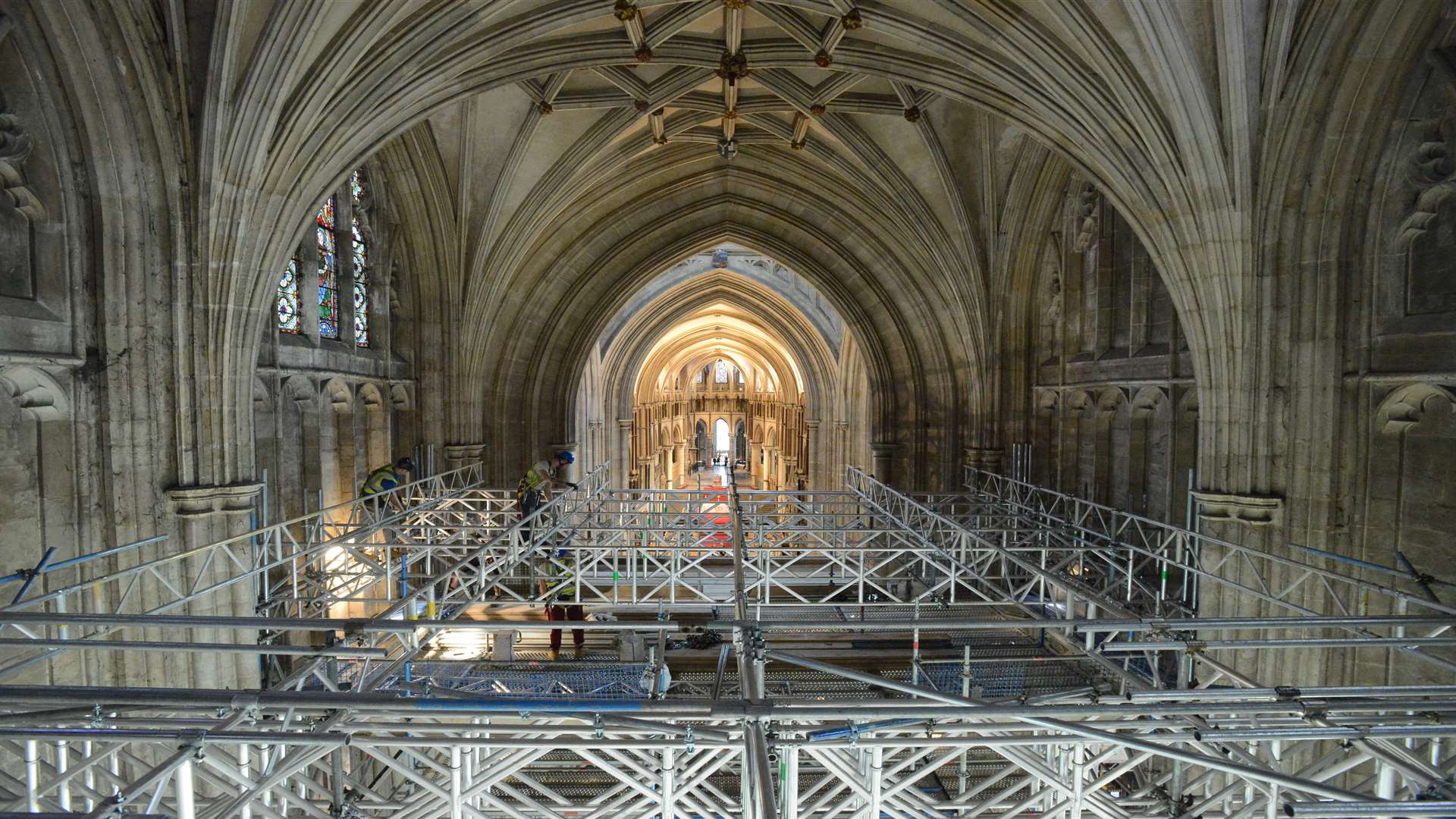 Scaffolders at work on the safety deck above the 15th century Cathedral Nave.