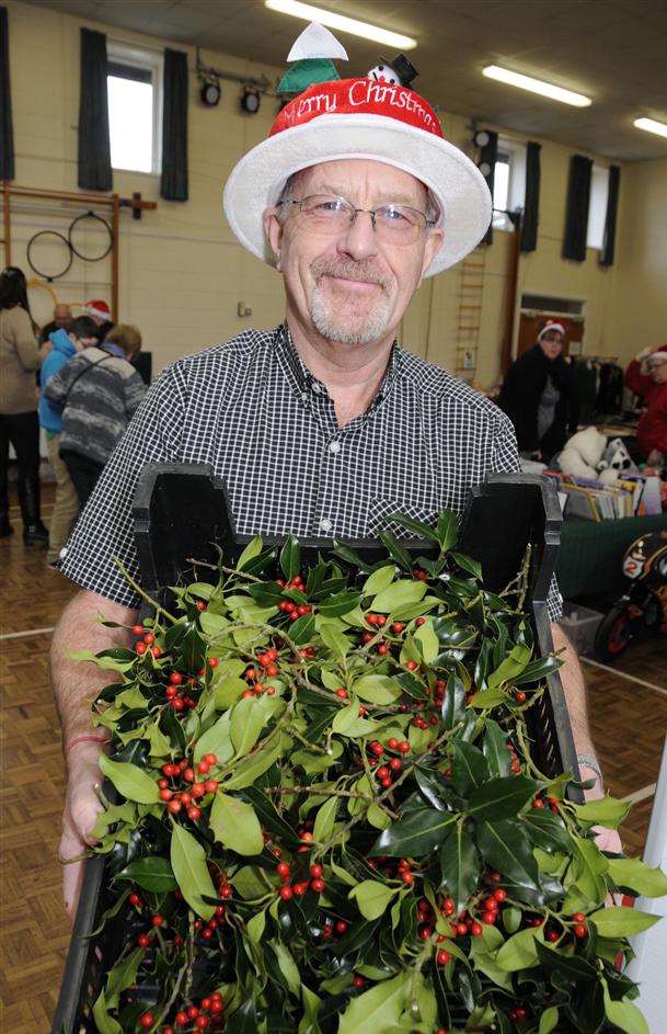 Church warden Dave Usher selling some of the holly at the Christmas fair