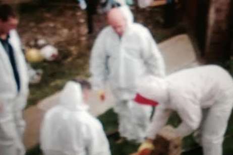 Workers in protective suits dug asbestos out of the family's garden
