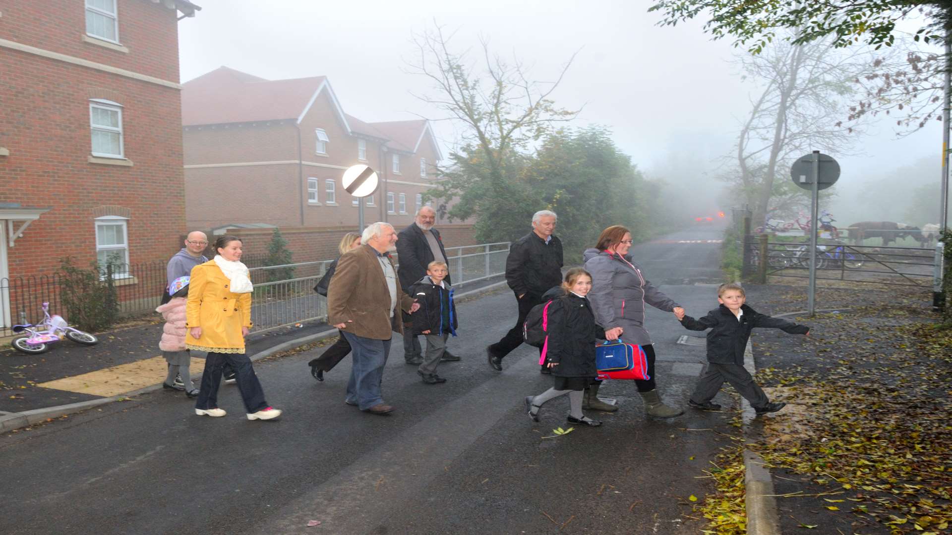 Parents, children and Labour councillors use the new crossing point they campaigned for