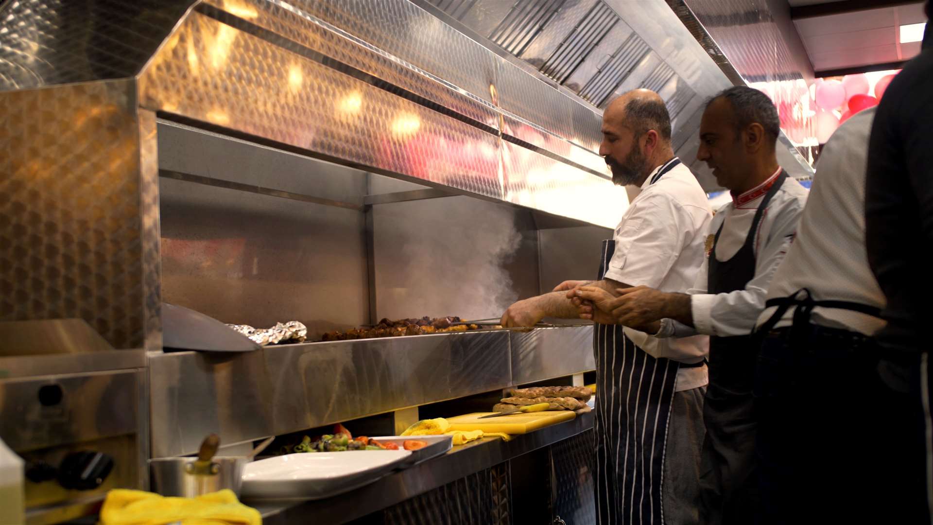 Workers cooking in Kaniklar Mangal restaurant in Week Street, Maidstone