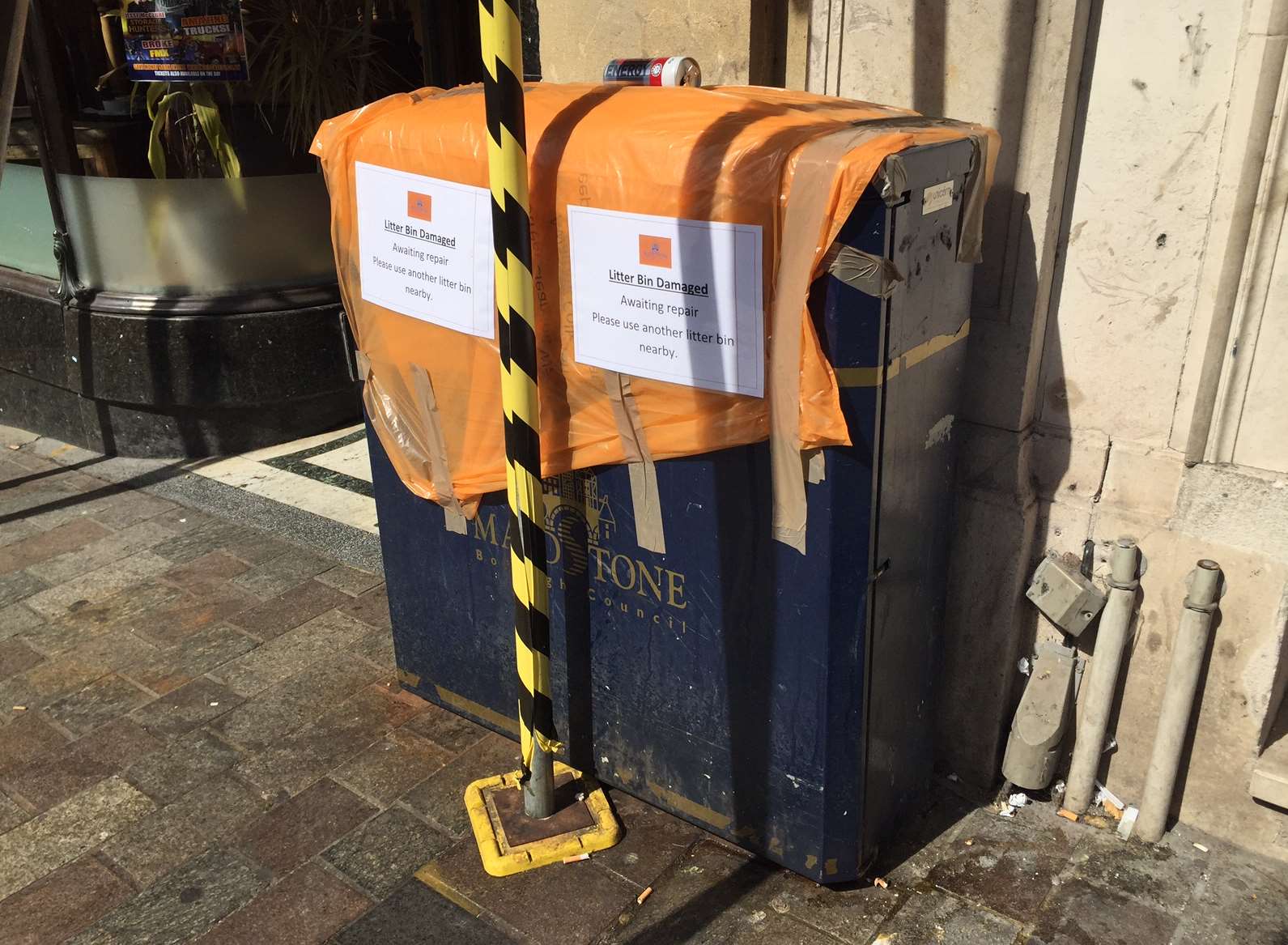 The bin was taped off after because scaffolding prevents workers from emptying it