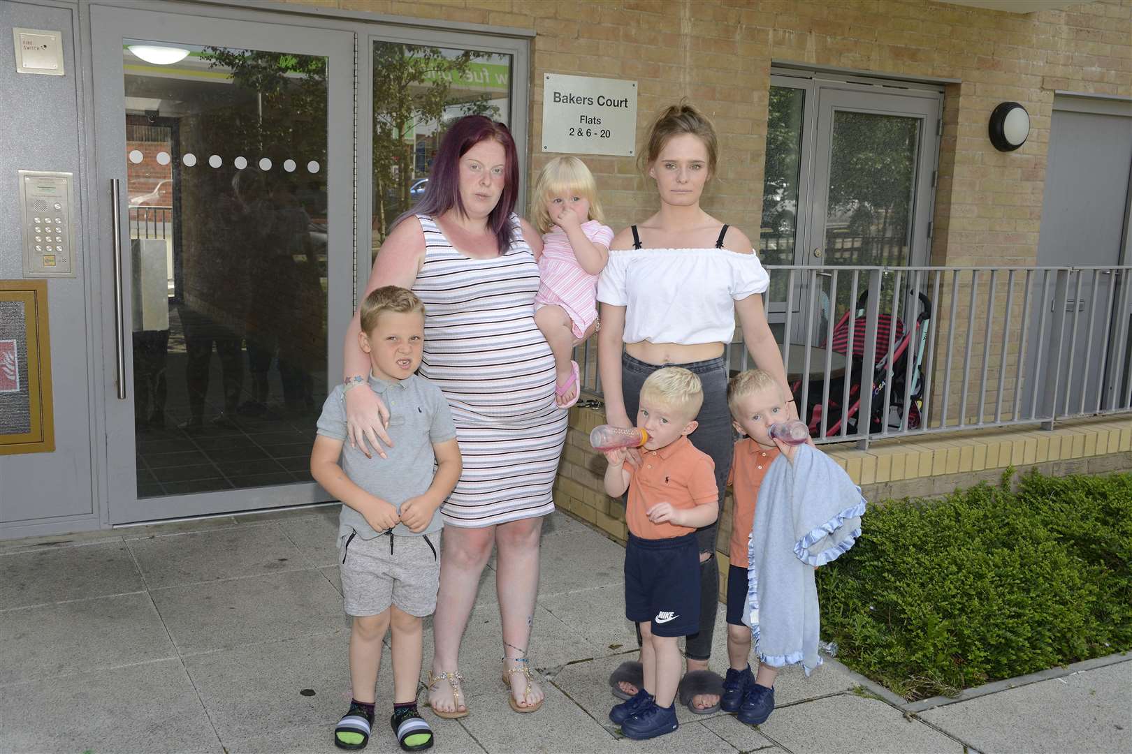 Bakers Court in Ashford without water on hottest day of year. Pictured is Sam Cox and Shannon Trott with their young family. Picture: Paul Amos