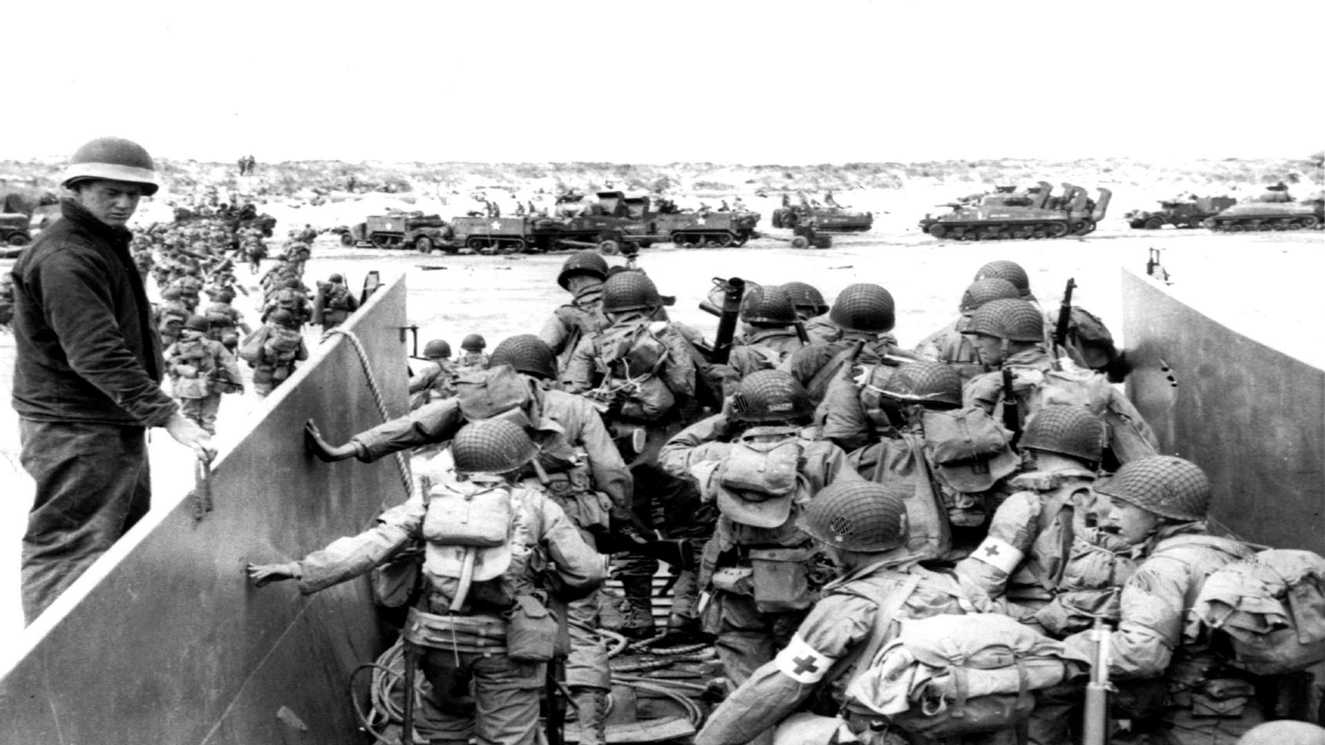 US Army soldiers disembark from a landing craft during the Normandy landings