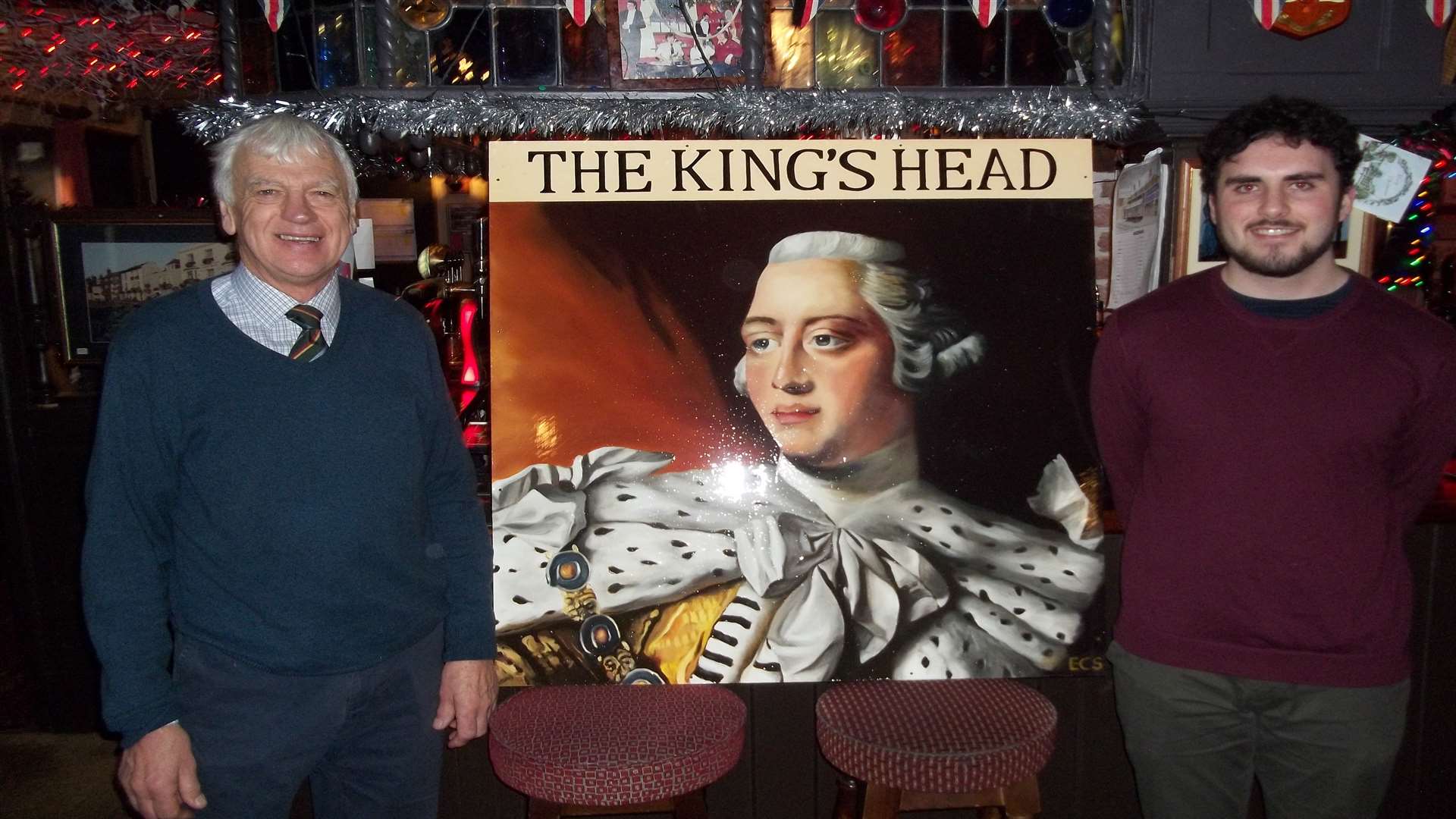 King's Head landlord Graham Stiles with the new sign and painter Edward Spencer