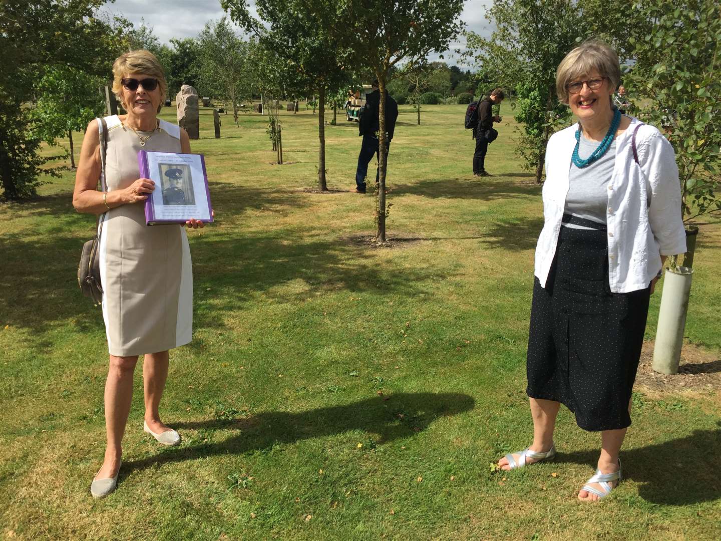 Sisters Jenny Carter and Christine Tomkinson, with a picture of their father Sgt Francis Railey (Richard Vernalls/PA)