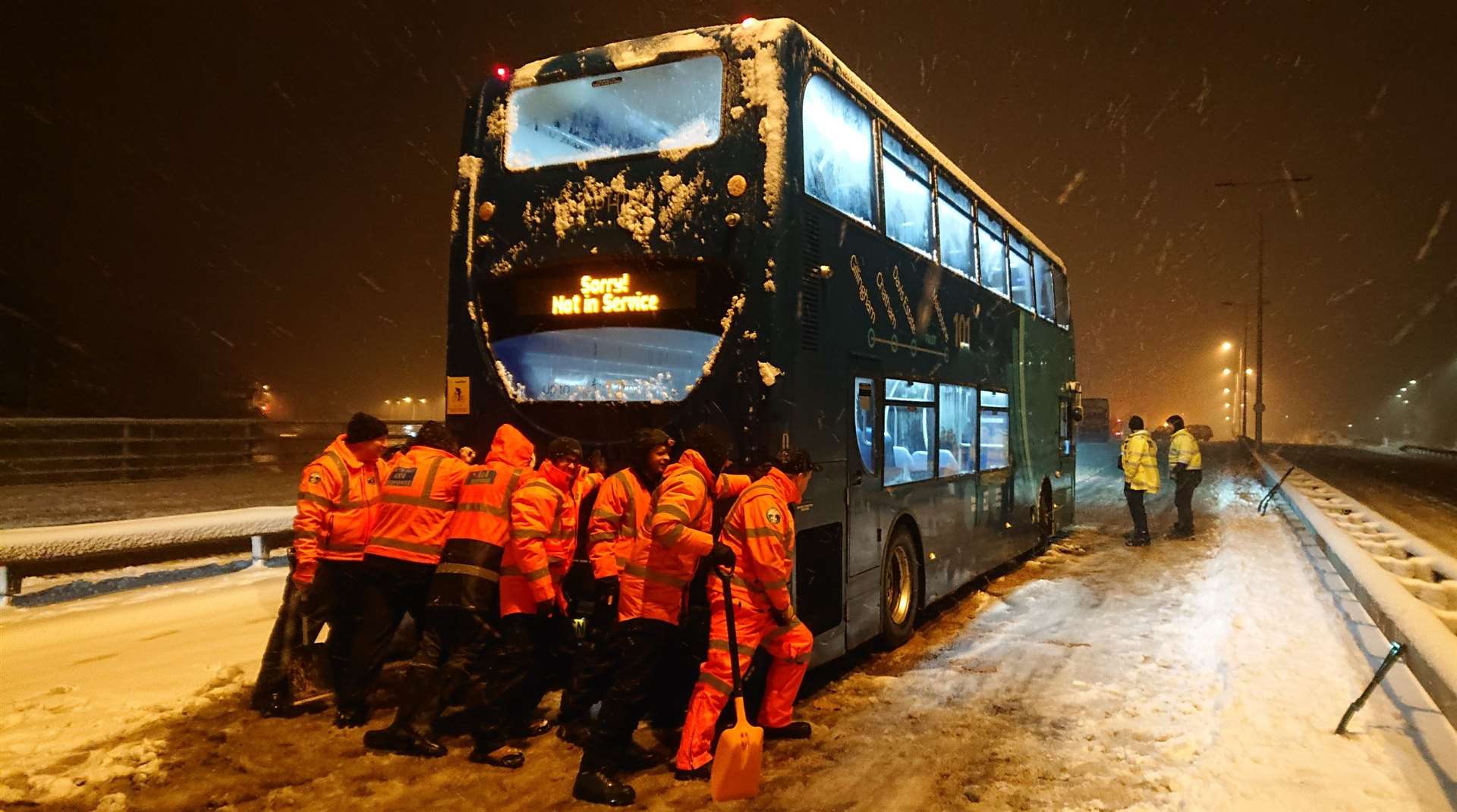 South East 4x4 Response members push a bus in the snow on Blue Bell Hill, in February 2018