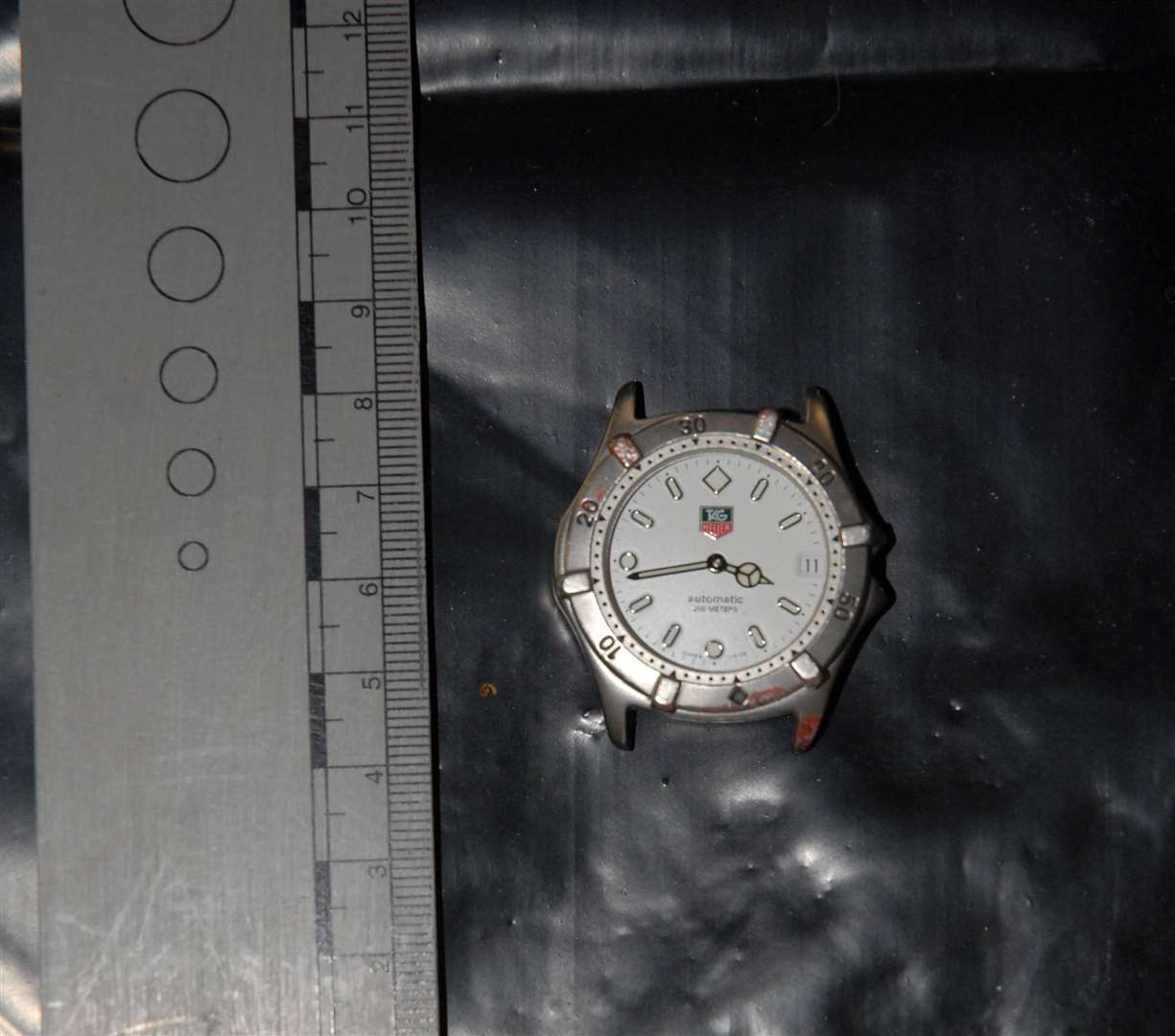 A piece of the broken Tag Heuer watch that belonged to Guy Malbec and which was smashed during the violence. It was found by police in pieces in the Castle Street car park. Picture: CPS