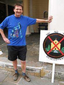 Hythe Fisherman's beach development protestor William Adams with one of the placards he displayed outside the Town Hall