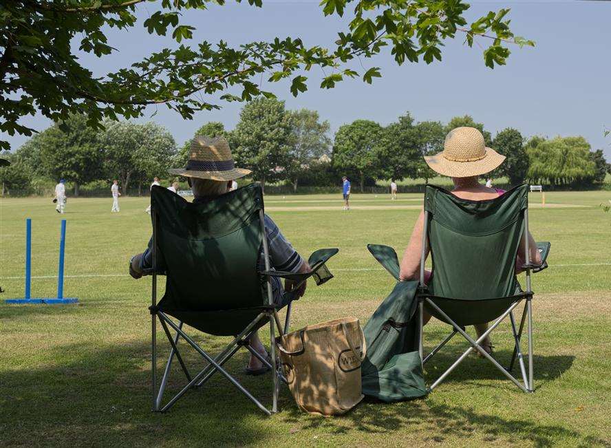 Watching cricket in sunshine. Library picture