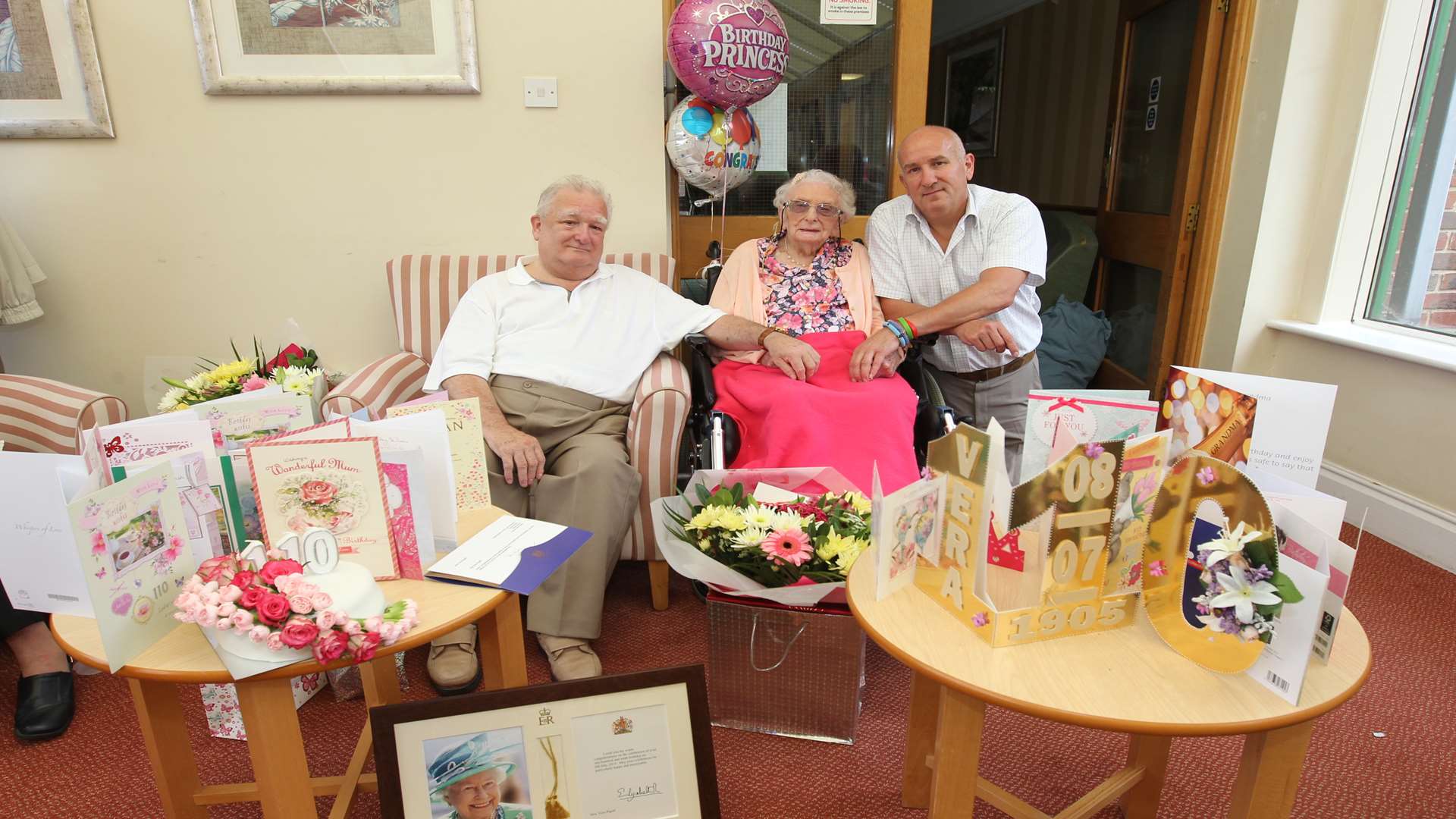 Vera Pigott, celebrates her 110th birthday with from left, Graham Pigott, son and Kevin Lee, grandson at Sutton Valence Care Home. Picture: John Westhrop.