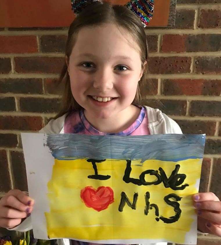 Megan with her NHS thank you poster, for looking after her daddy, Dave. Picture: Claire White