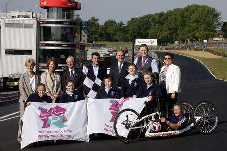 Seb Coe is joined by Jonathan Palmer, members of the local council, children from Valence School and Paralympian Rachel Morris on the start/finish straight at Brands Hatch