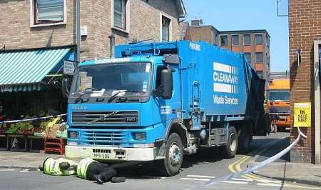 Police crash investigators inspect the Cleanaway lorry after fatal accident