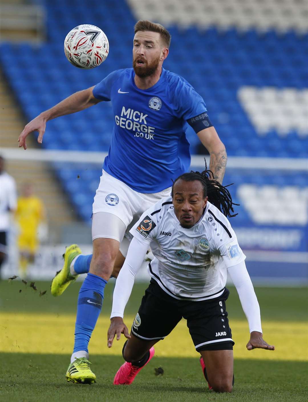 Dover's Ricky Modeste takes a tumble against Peterborough United Picture: Andy Jones