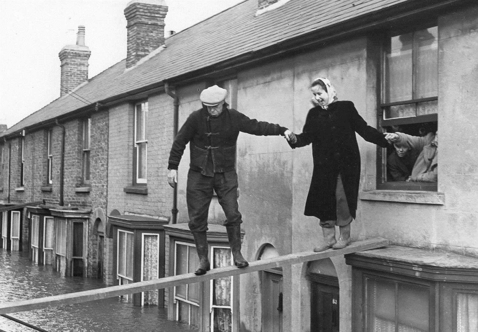 A woman being rescued from an upstairs room at Island Walk, Whitstable, during the floods of 1953