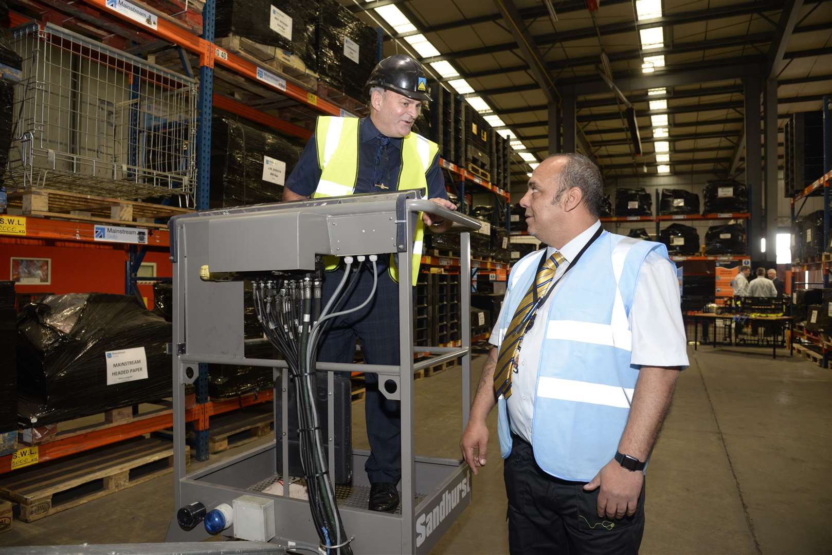 Joe Rook, community engagement manager at Standford Hill Prison is instructed on a 'cherry picker' by Kevin Dardis during an open day at Mainstream House, Eurolink Estate, Sittingbourne. Picture: Chris Davey