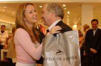 ALL SMILES: Actress Amanda Holden is greeted by John Coleman, chief executive of House of Fraser