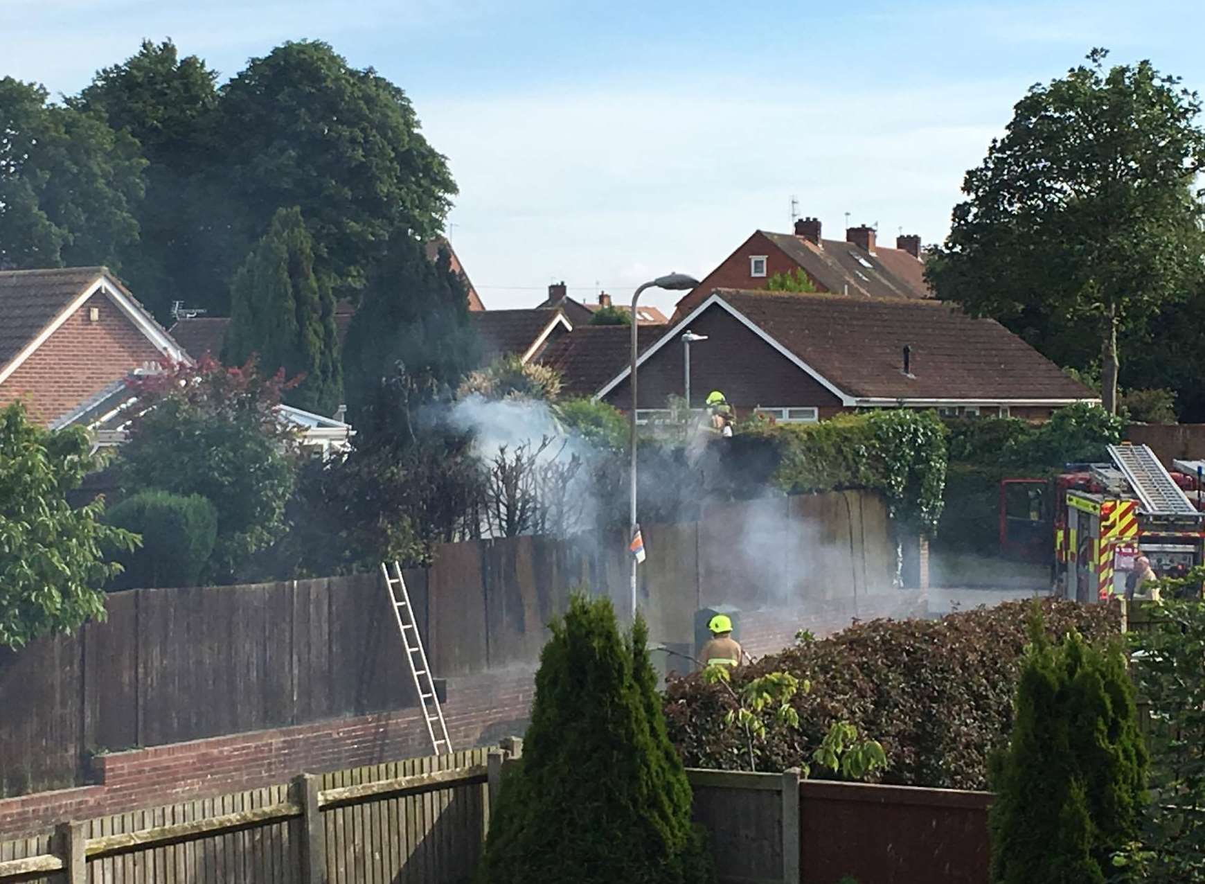 Firefighters tackled the fence and hedge fire in Rectory Road, Deal. Photo: Ed Baker