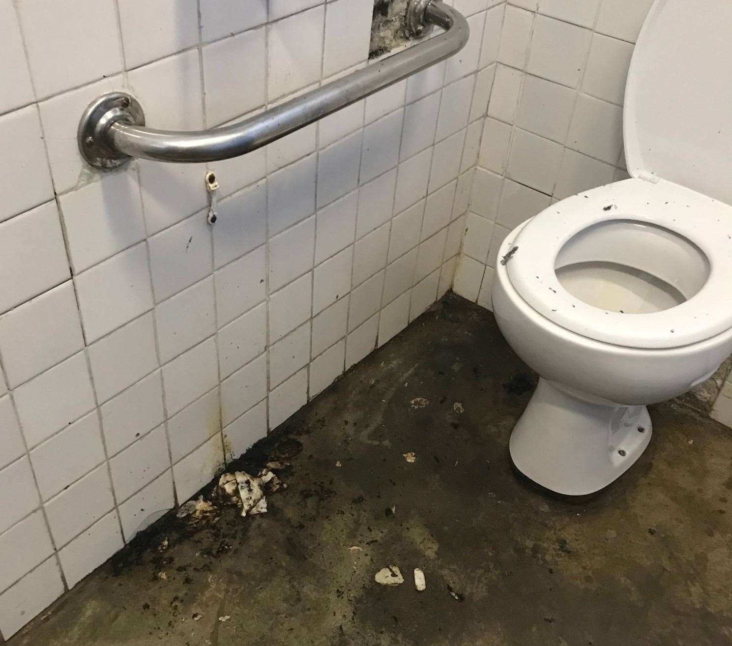 Burnt pieces of toilet roll were strewn over the floor