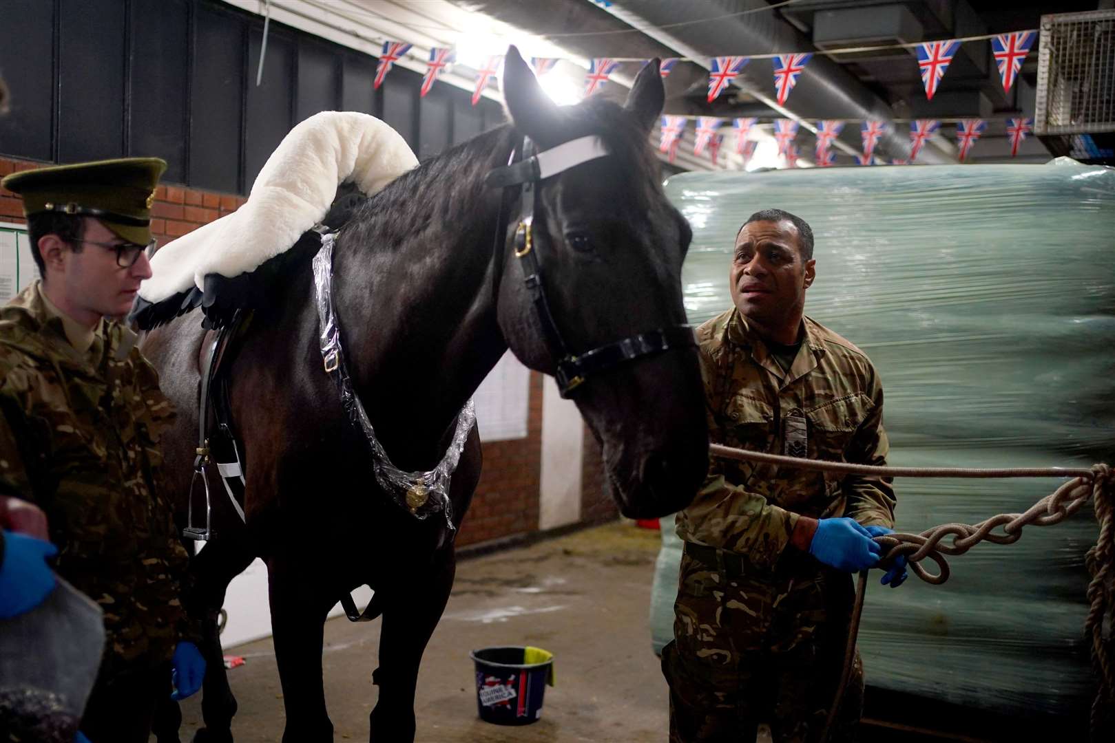 Members of the Life Guards prepare their horse (Victoria Jones/PA)