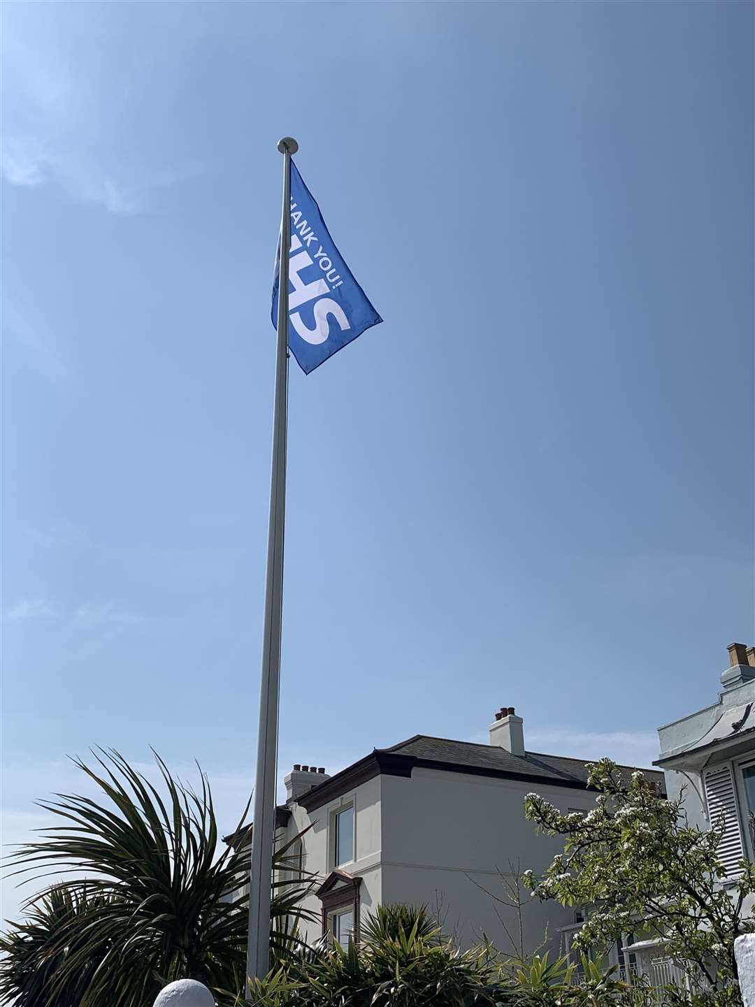 'Thank you NHS' is the message on a flag being flown in a seafront garden