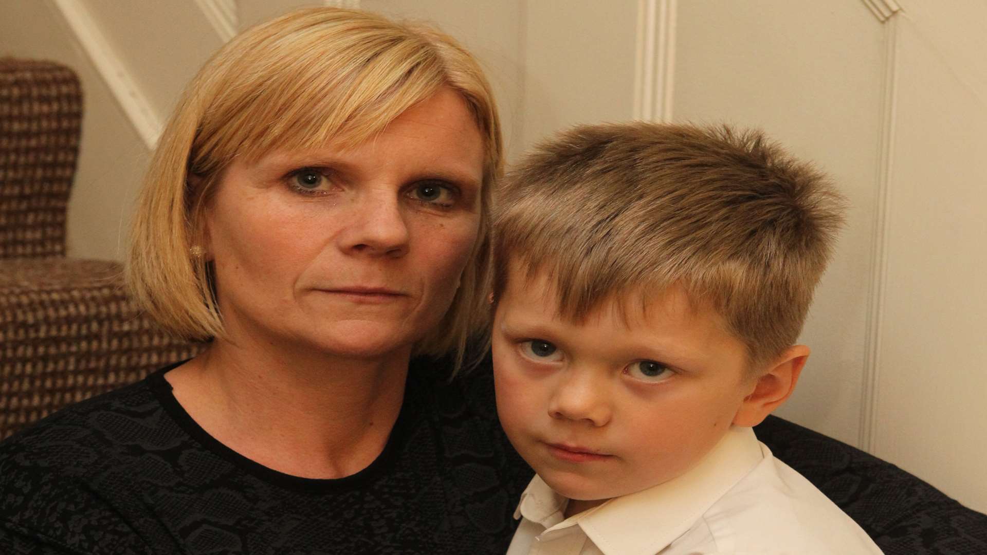 Faye May with her son, Ozzie, five who was not allowed to see the Inside Out film at School because he didn't have 100% attendance. He missed a handful of days due to a road accident which has left a scar on his right hand.