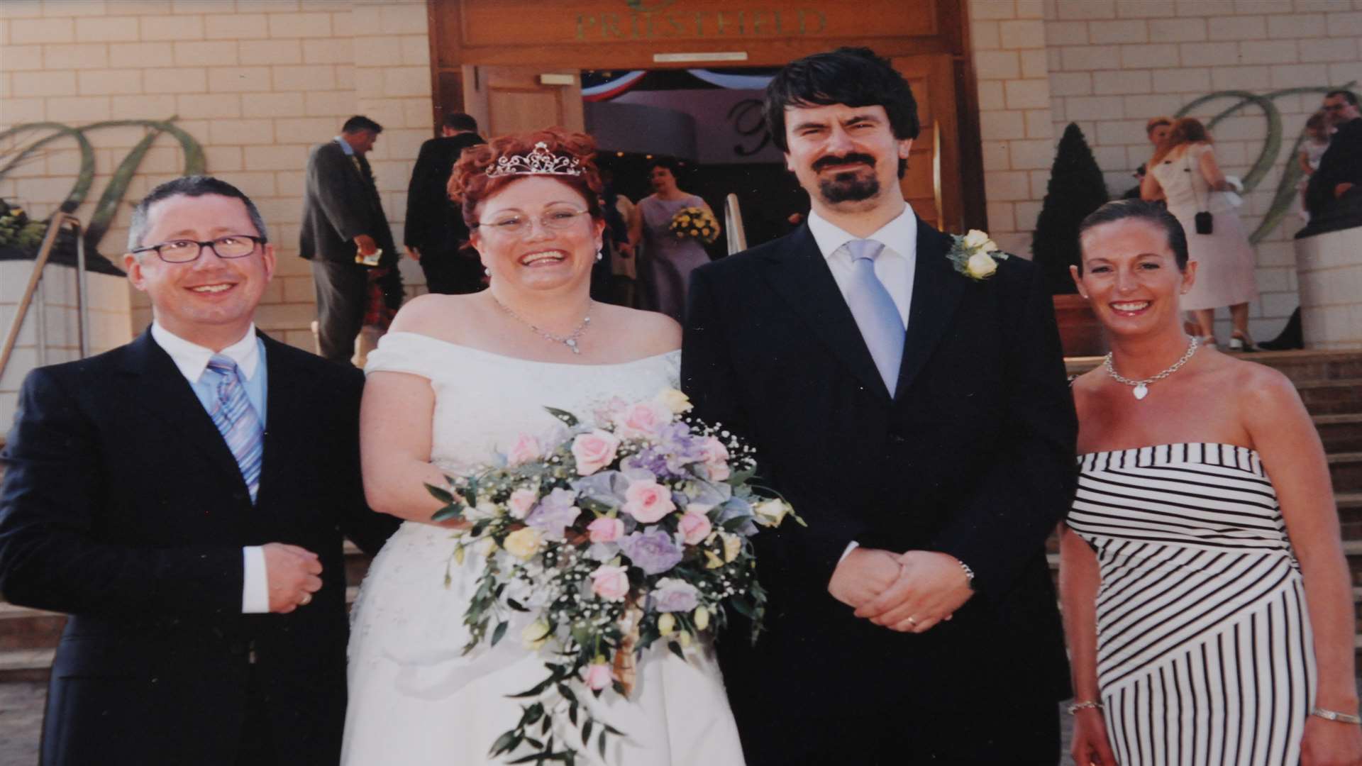 Super Gills fan Peter and Melanie Lloyd on their wedding day with Paul Scally (left)