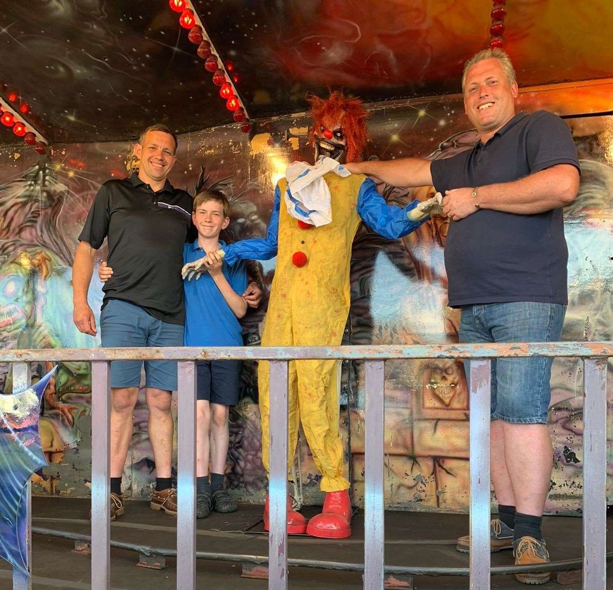 Reece Brett, left, and his son Little Reece, 12, need someone to fill the shoes of this horror clown on the Graveyard Express ghost train when it joins Carlos Christian's Smith's Family Funfair at Leysdown, Sheppey